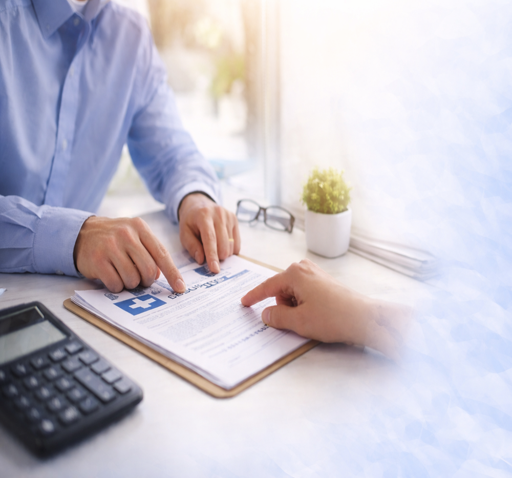 Insurance advisors meeting with a client in a modern office